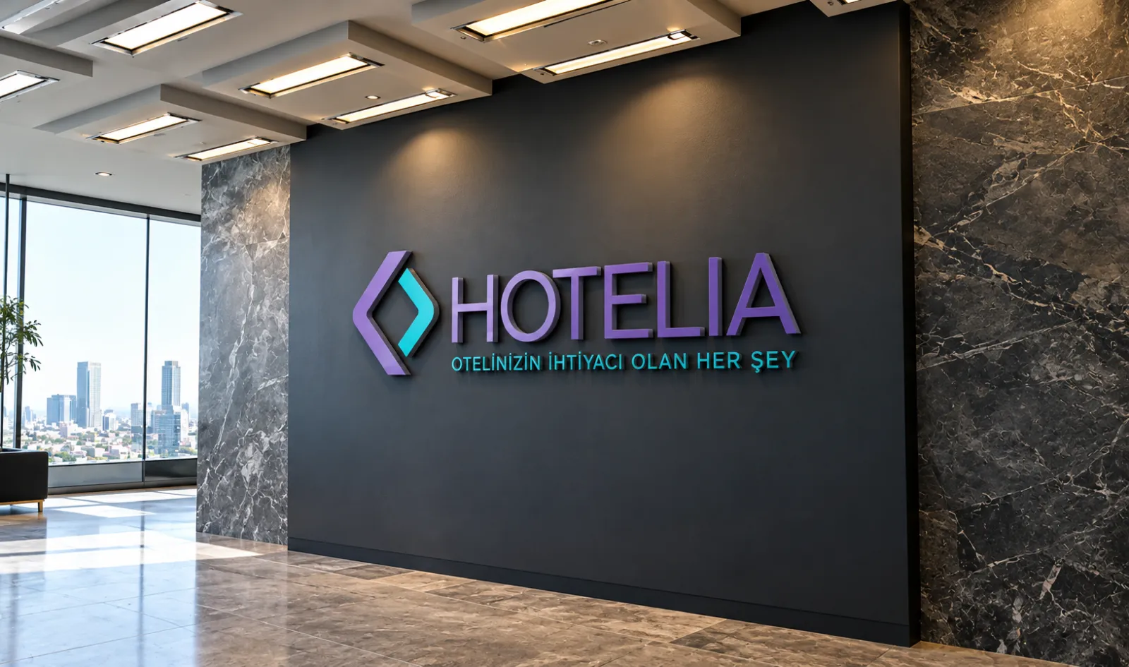 Hotelia ofisinin girişinde, koyu duvarda Hotelia logosu